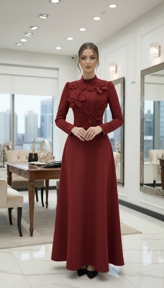 Woman in a red dress standing in a modern interior setting with large windows.